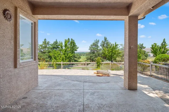 a view of a green field with wooden fence