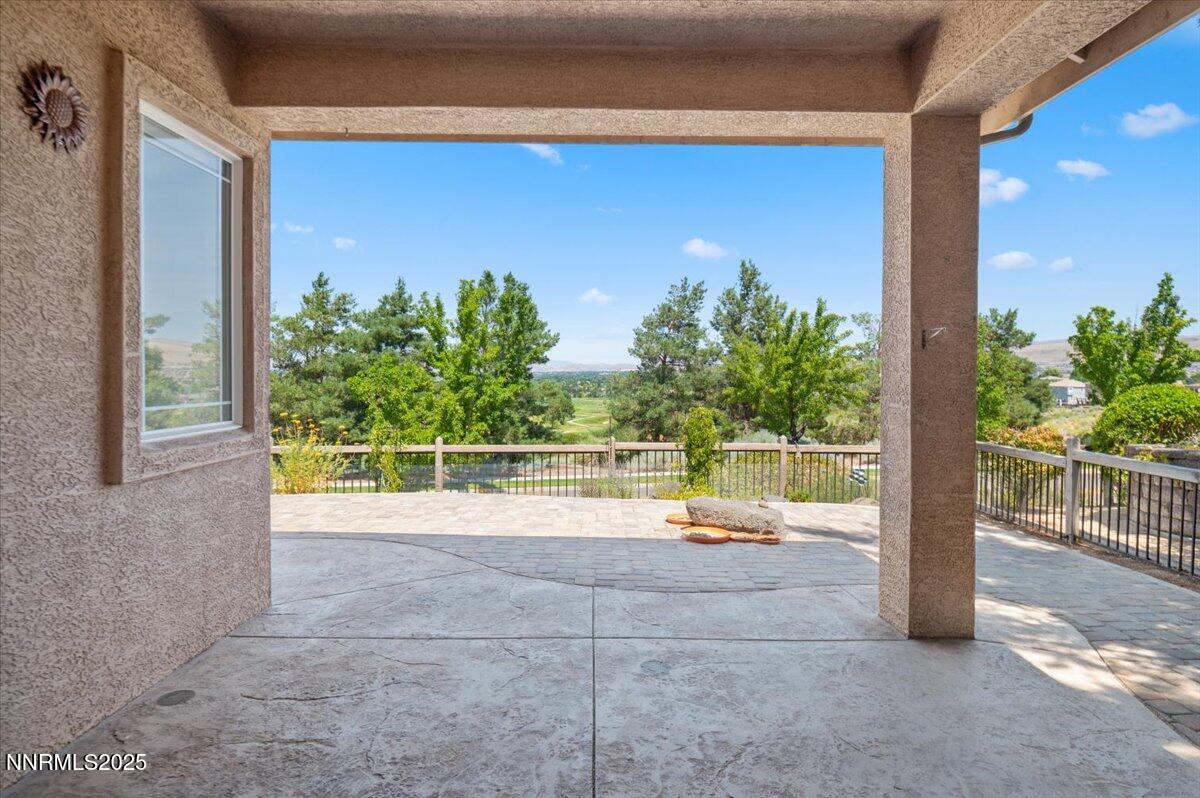 2720 Albazano Drive Sparks, NV 89436 - Photo 39 of 47 a view of a porch with a floor to ceiling window and potted plants