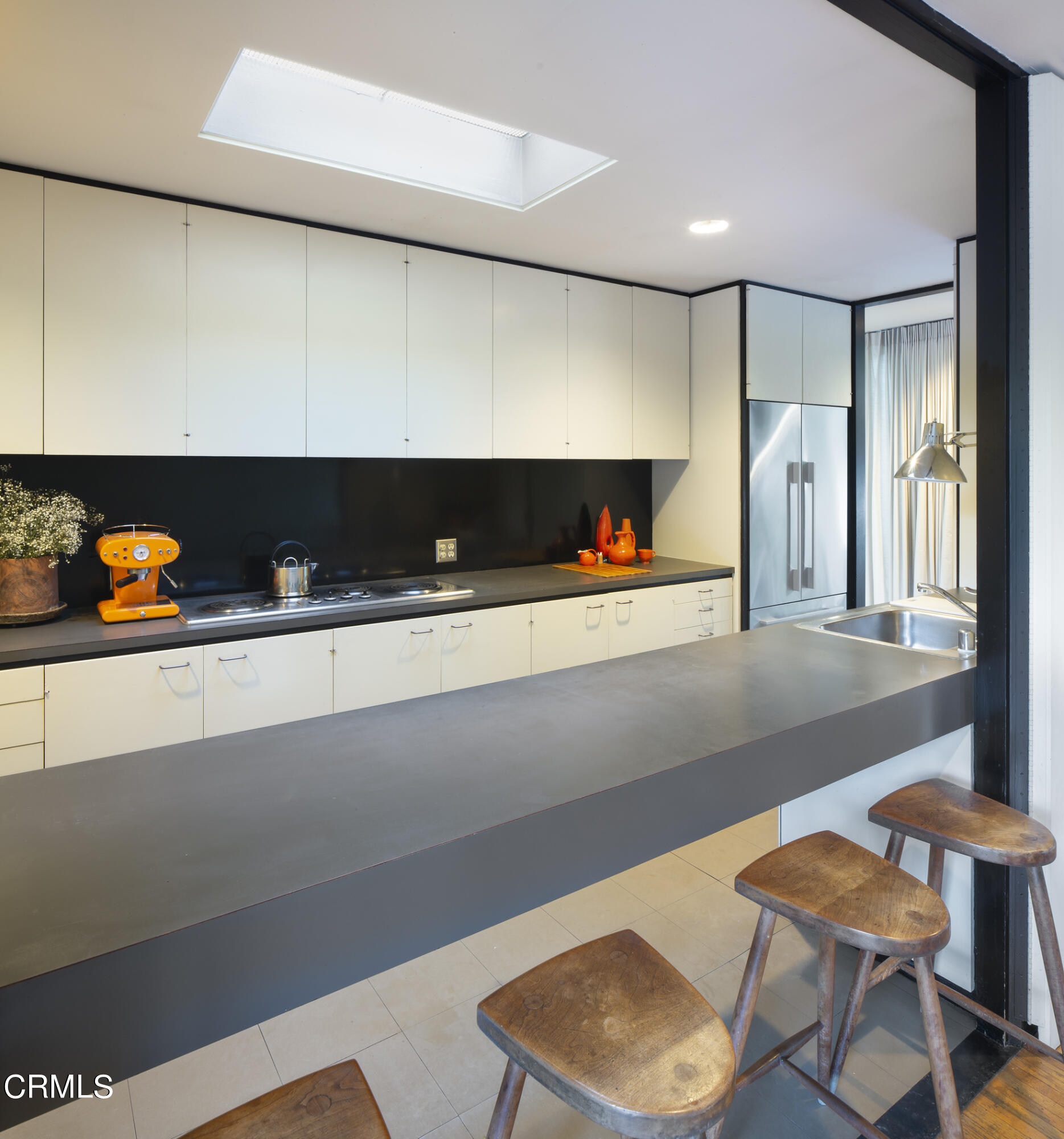 215 La Vereda Road Pasadena, CA 91105 - Photo 11 of 26 a living room with chairs and a table