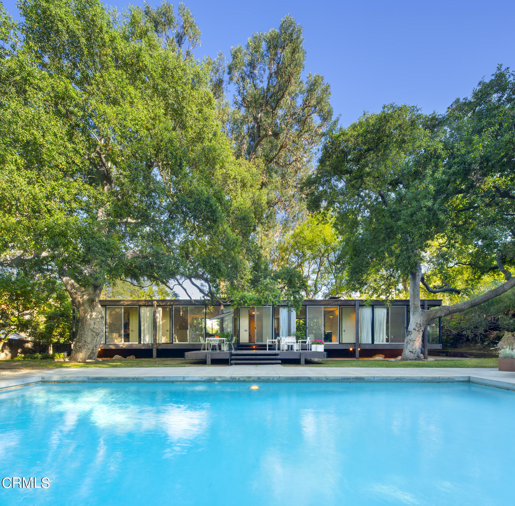 215 La Vereda Road Pasadena, CA 91105 - Photo 19 of 26 a front view of a house with swimming pool having outdoor seating