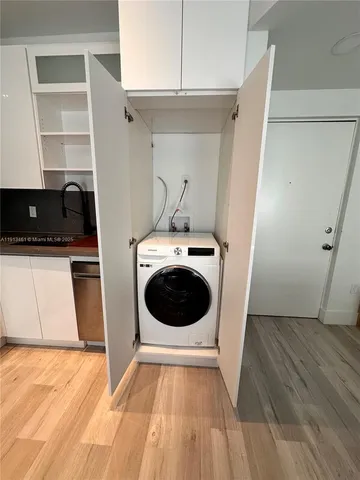 a view of a kitchen with a sink and dishwasher