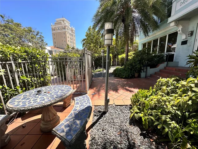 a view of a patio with table and chairs and potted plants