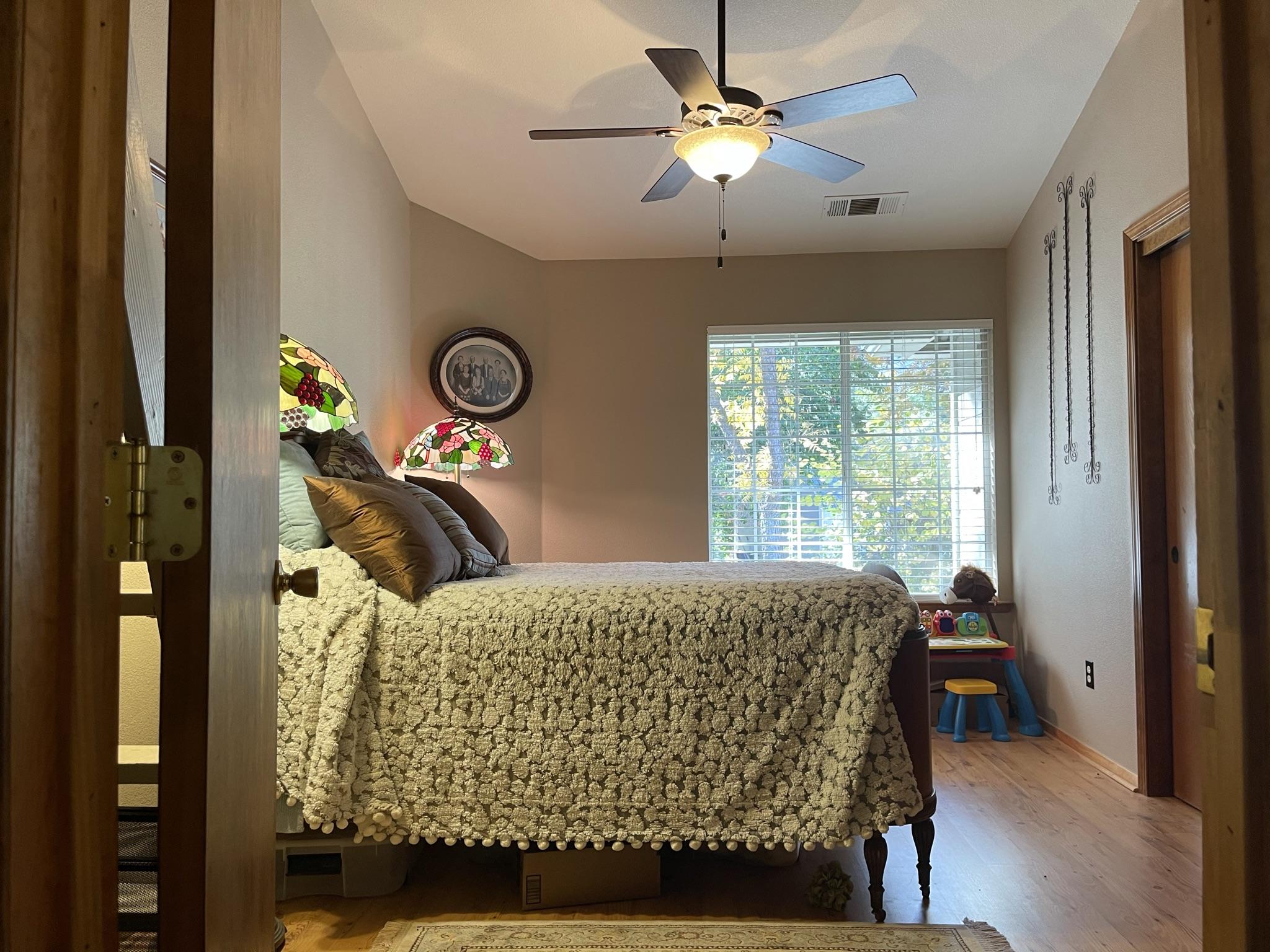 40964 Cherokee Oaks Drive Three Rivers, CA 93271 - Photo 22 of 41 a bed sitting in a bedroom next to a window