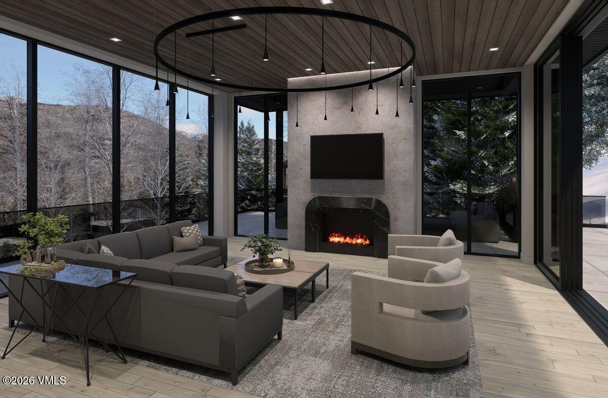 296 Rockledge Road Vail, CO 81657 - Photo 12 of 63 a living room with furniture a fireplace and a floor to ceiling window