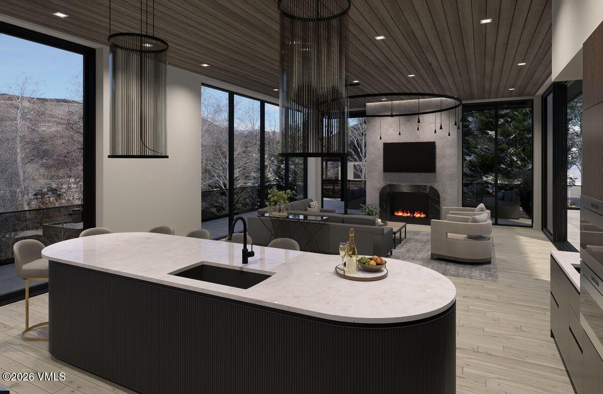 296 Rockledge Road Vail, CO 81657 - Photo 20 of 63 a kitchen with a sink a counter top space and living room view