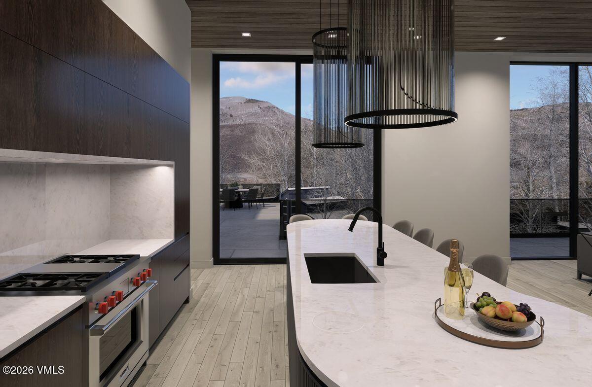 296 Rockledge Road Vail, CO 81657 - Photo 24 of 63 a kitchen with a refrigerator and wooden floor