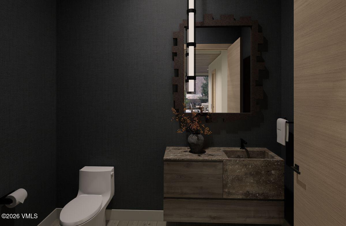 296 Rockledge Road Vail, CO 81657 - Photo 31 of 63 a bathroom with a toilet sink and mirror