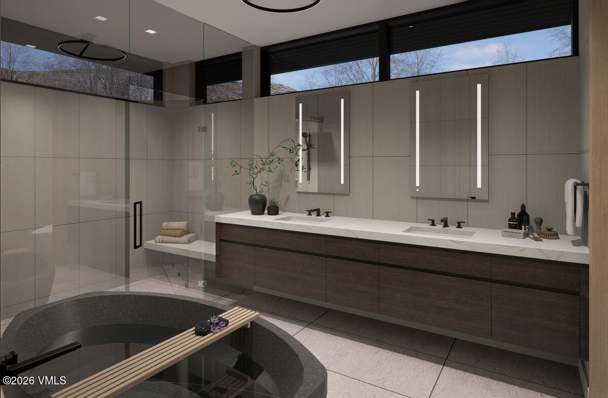 296 Rockledge Road Vail, CO 81657 - Photo 38 of 63 a bathroom with a bathtub sink vanity and mirror