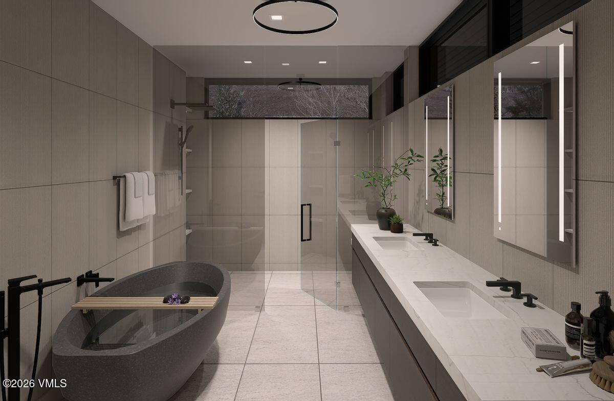 296 Rockledge Road Vail, CO 81657 - Photo 39 of 63 a bathroom with a tub sink a toilet and mirror