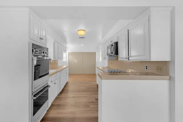 a kitchen with stainless steel appliances granite countertop a stove and a sink