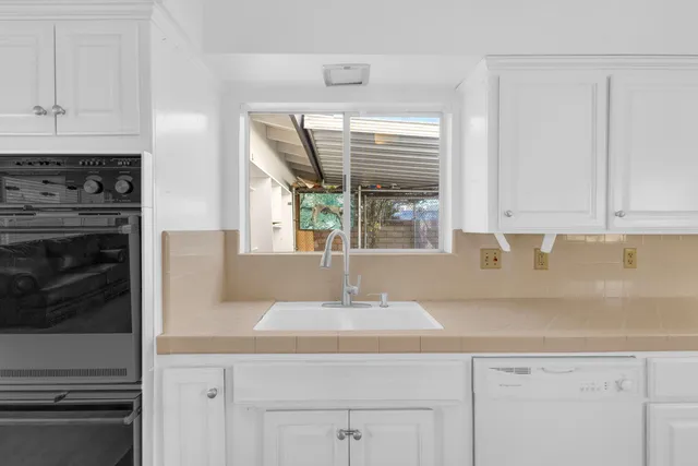 a kitchen with sink and cabinets