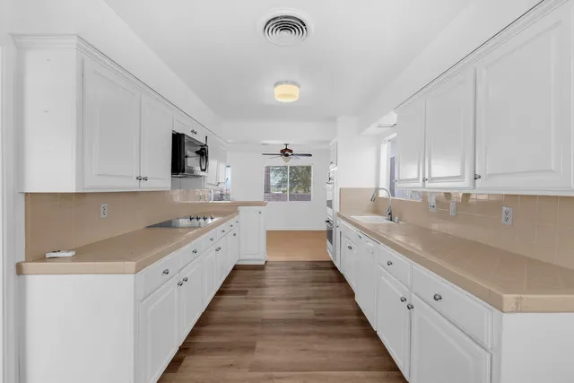 a kitchen with sink and cabinets