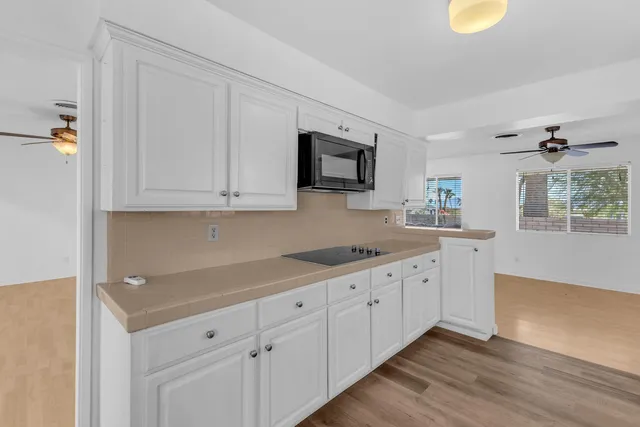 a kitchen with white cabinets and a sink