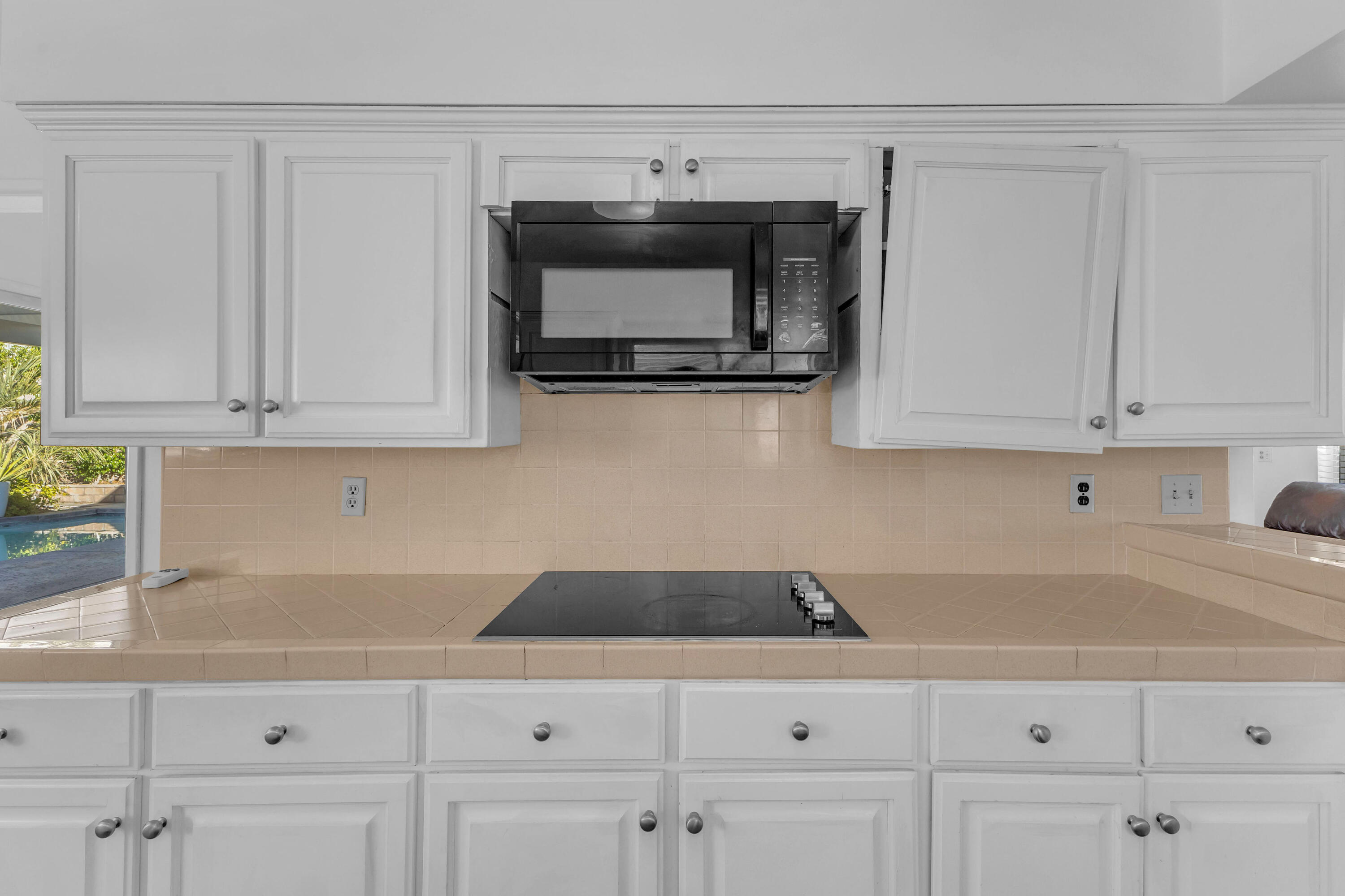 66180 14th Street Desert Hot Springs, CA 92240 - Photo 19 of 42 a kitchen with white cabinets and a sink
