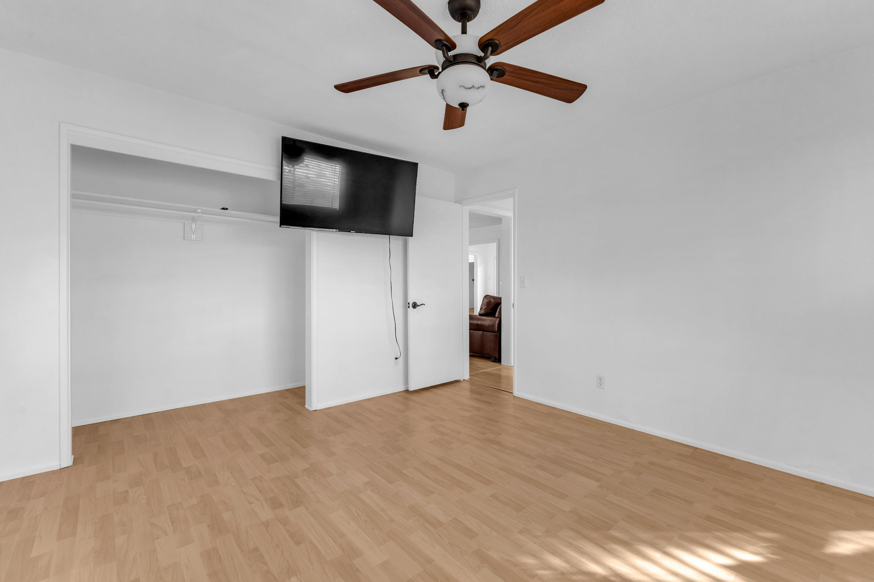 66180 14th Street Desert Hot Springs, CA 92240 - Photo 27 of 42 a view of an empty room with wooden floor and a window