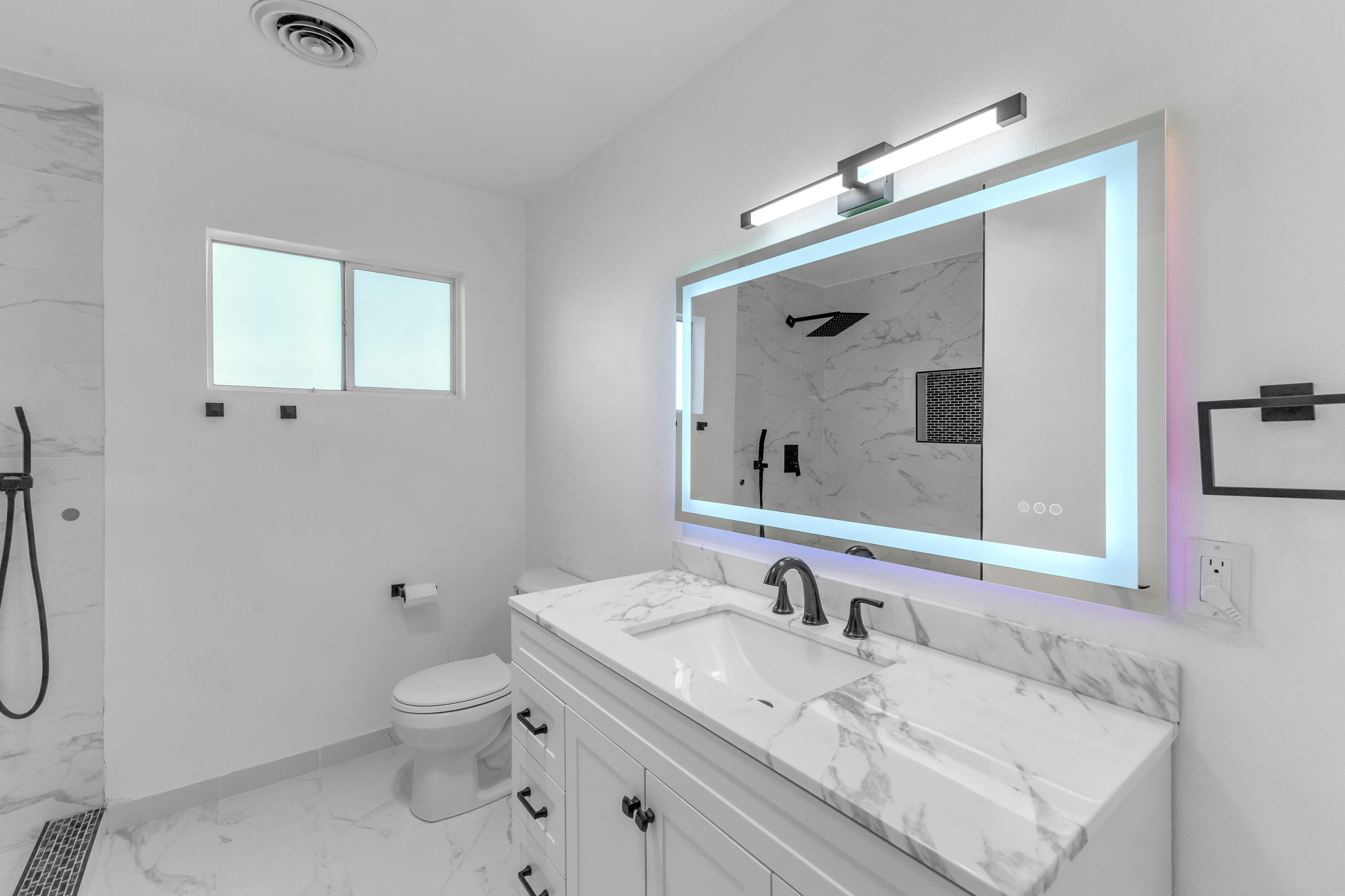 66180 14th Street Desert Hot Springs, CA 92240 - Photo 28 of 42 a bathroom with a granite countertop sink mirror and a toilet