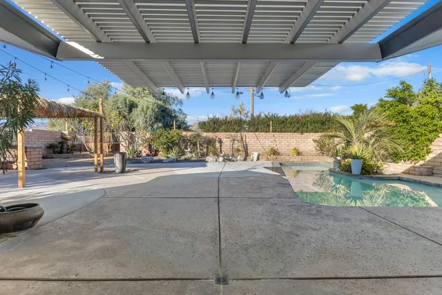 a view of a swimming pool with a patio