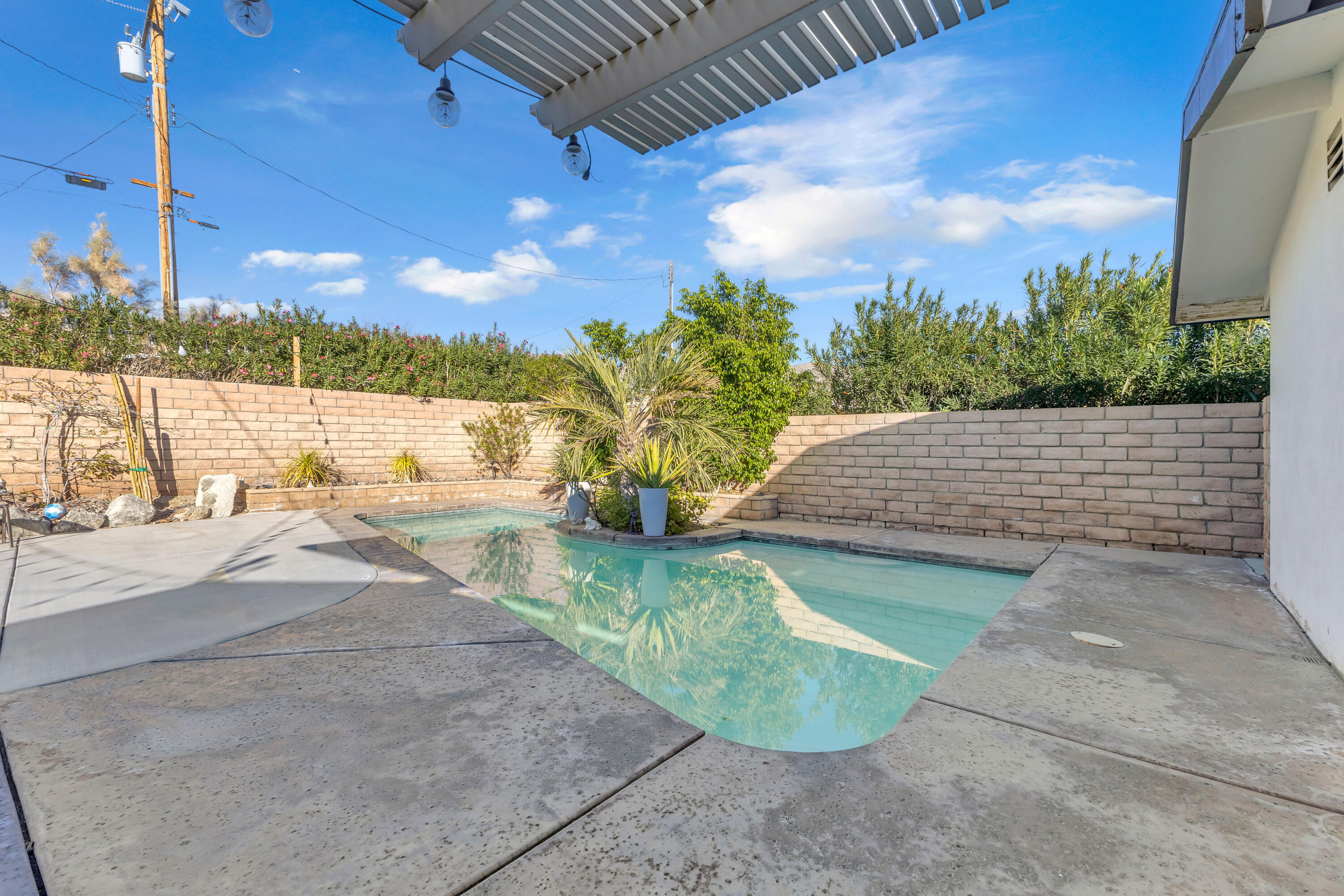 66180 14th Street Desert Hot Springs, CA 92240 - Photo 31 of 42 a view of a swimming pool with a patio
