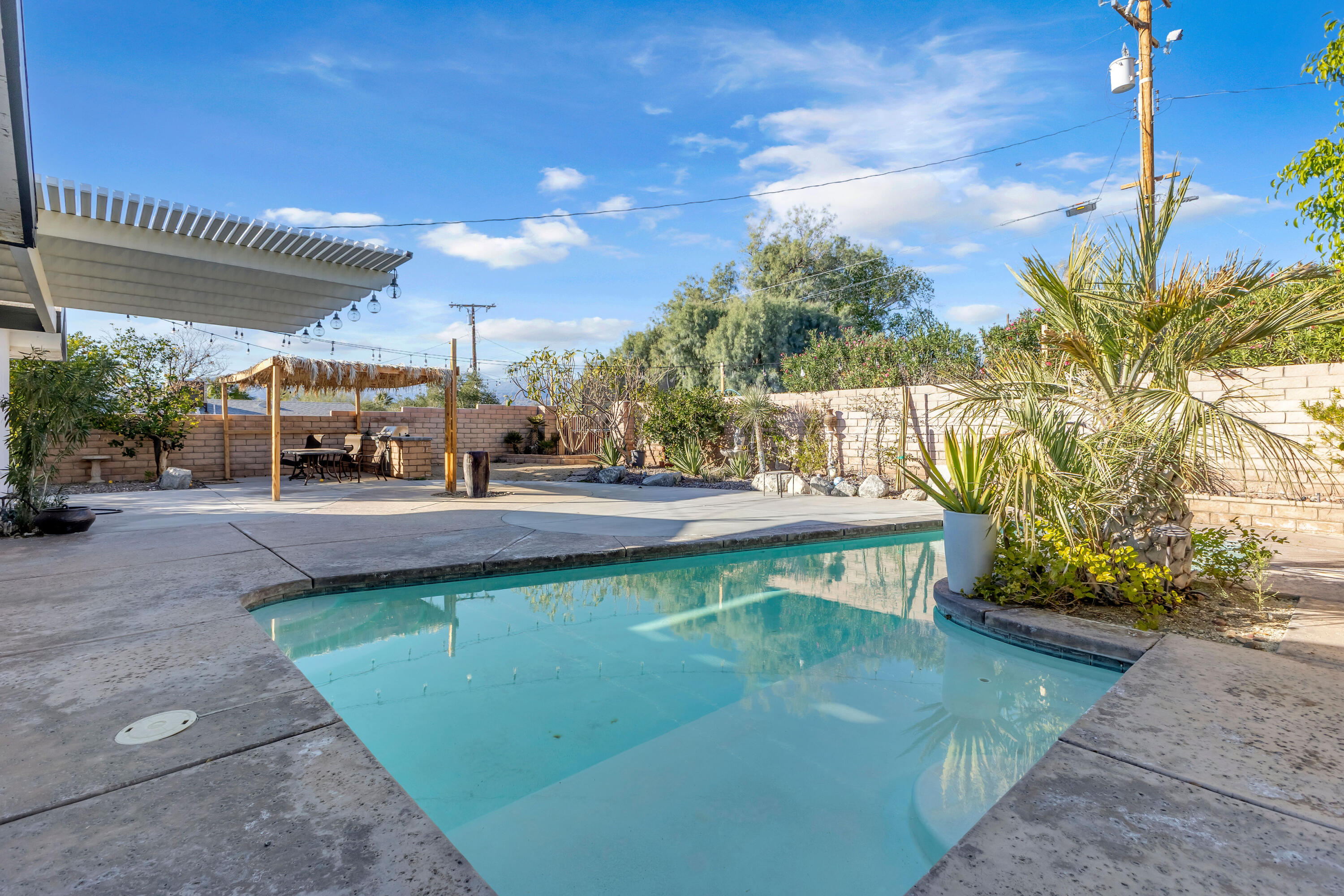 66180 14th Street Desert Hot Springs, CA 92240 - Photo 35 of 42 a view of a swimming pool with a patio