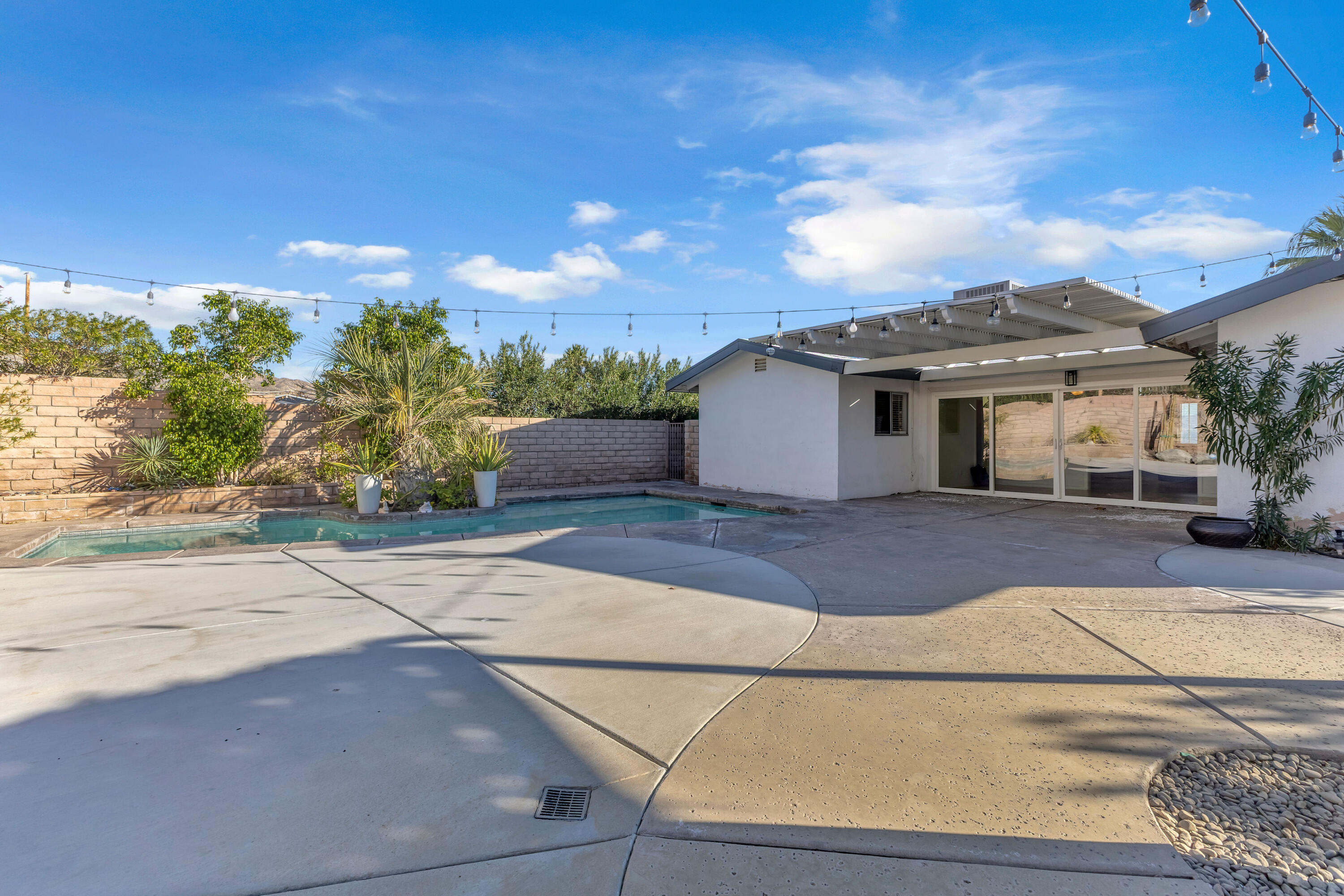 66180 14th Street Desert Hot Springs, CA 92240 - Photo 38 of 42 a front view of a house with a yard and garage