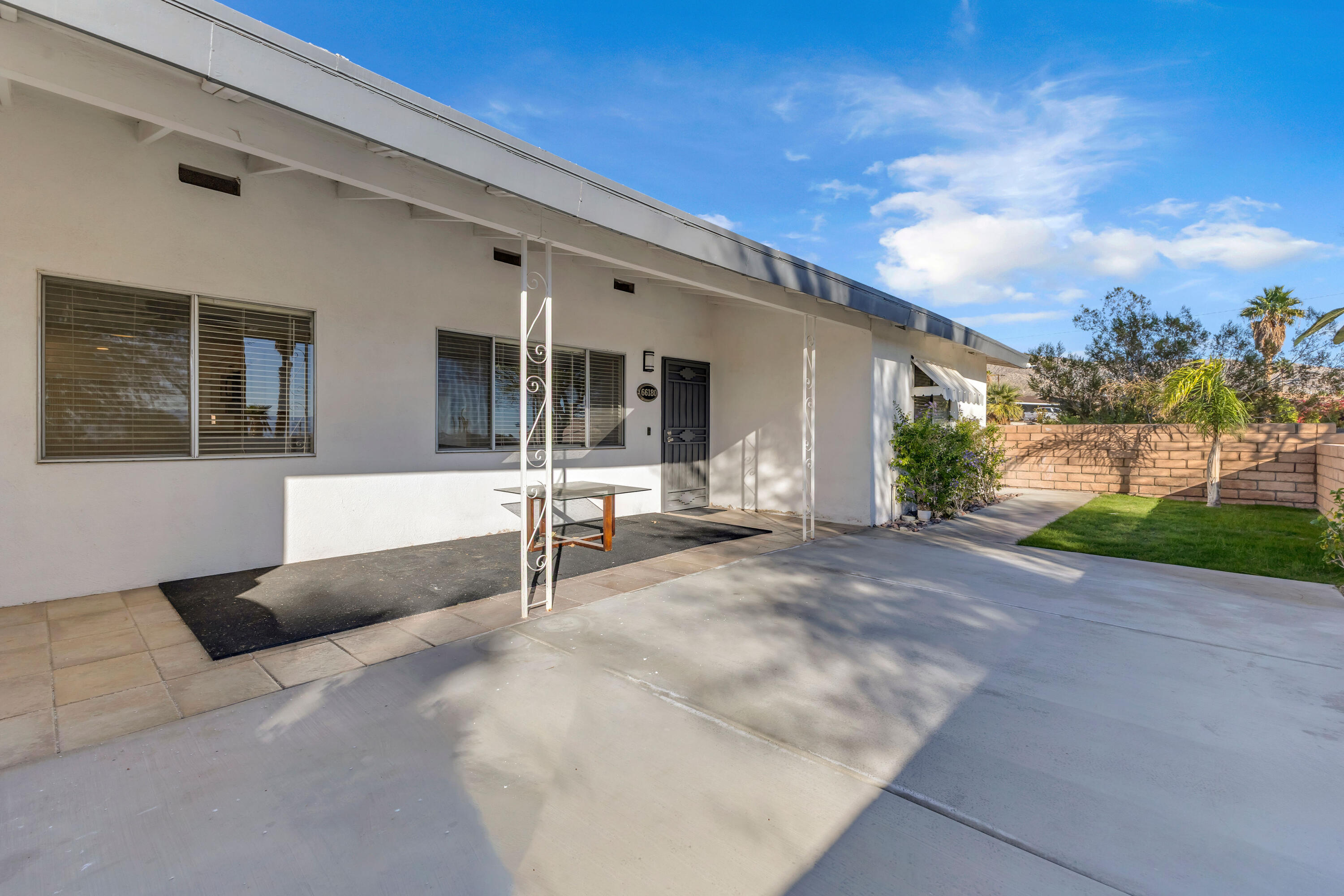 66180 14th Street Desert Hot Springs, CA 92240 - Photo 4 of 42 a view of a house with backyard and sitting area