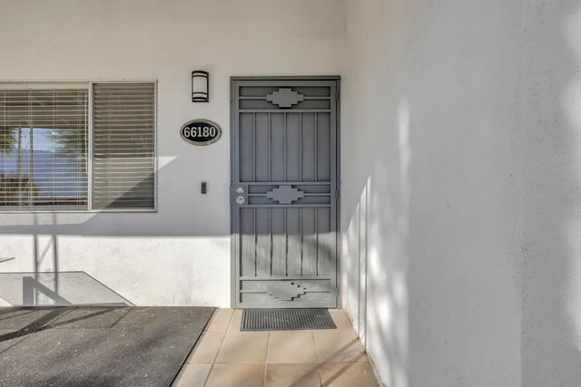 a view of a porch with a table and chairs