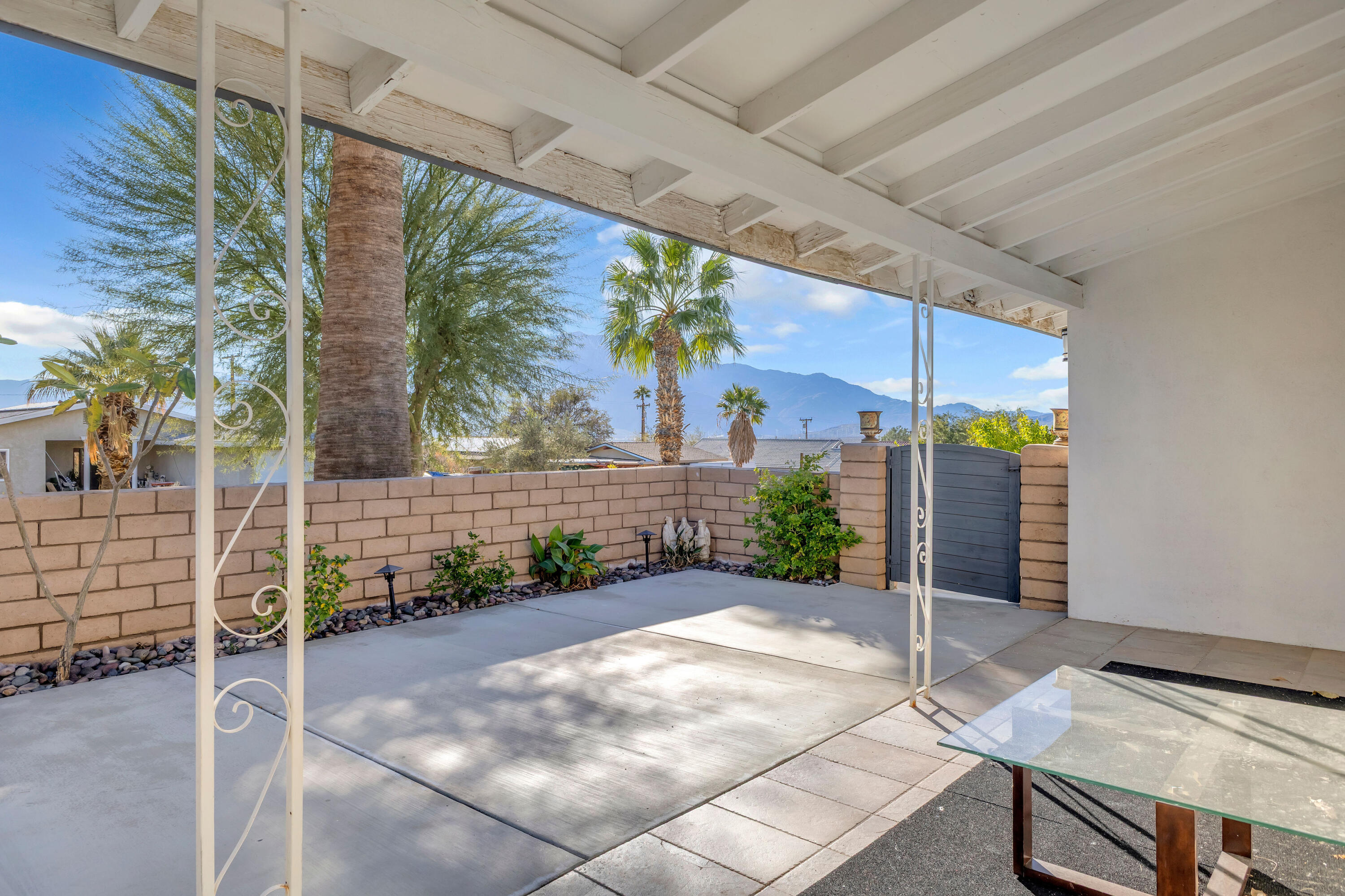 66180 14th Street Desert Hot Springs, CA 92240 - Photo 7 of 42 a view of a porch with a table and chairs