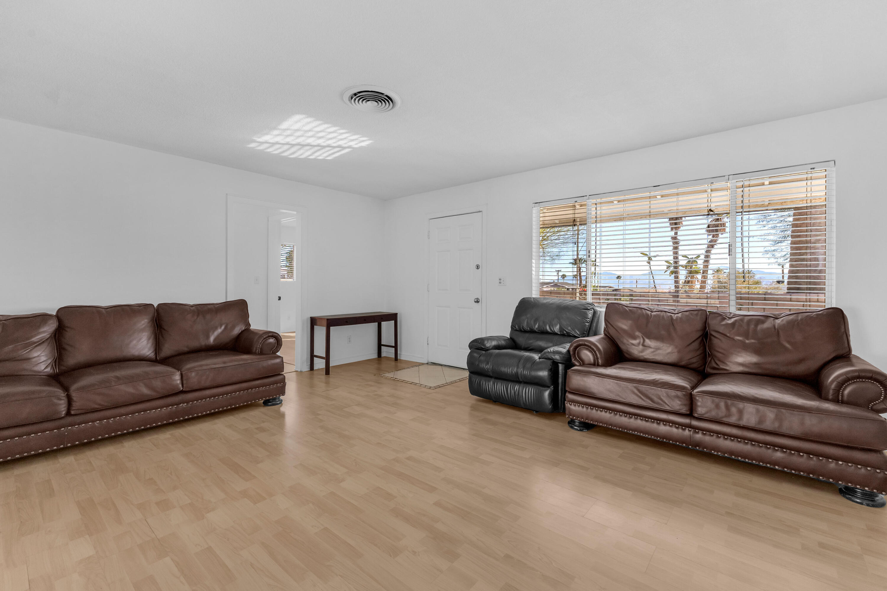 66180 14th Street Desert Hot Springs, CA 92240 - Photo 10 of 42 a living room with furniture and a large window