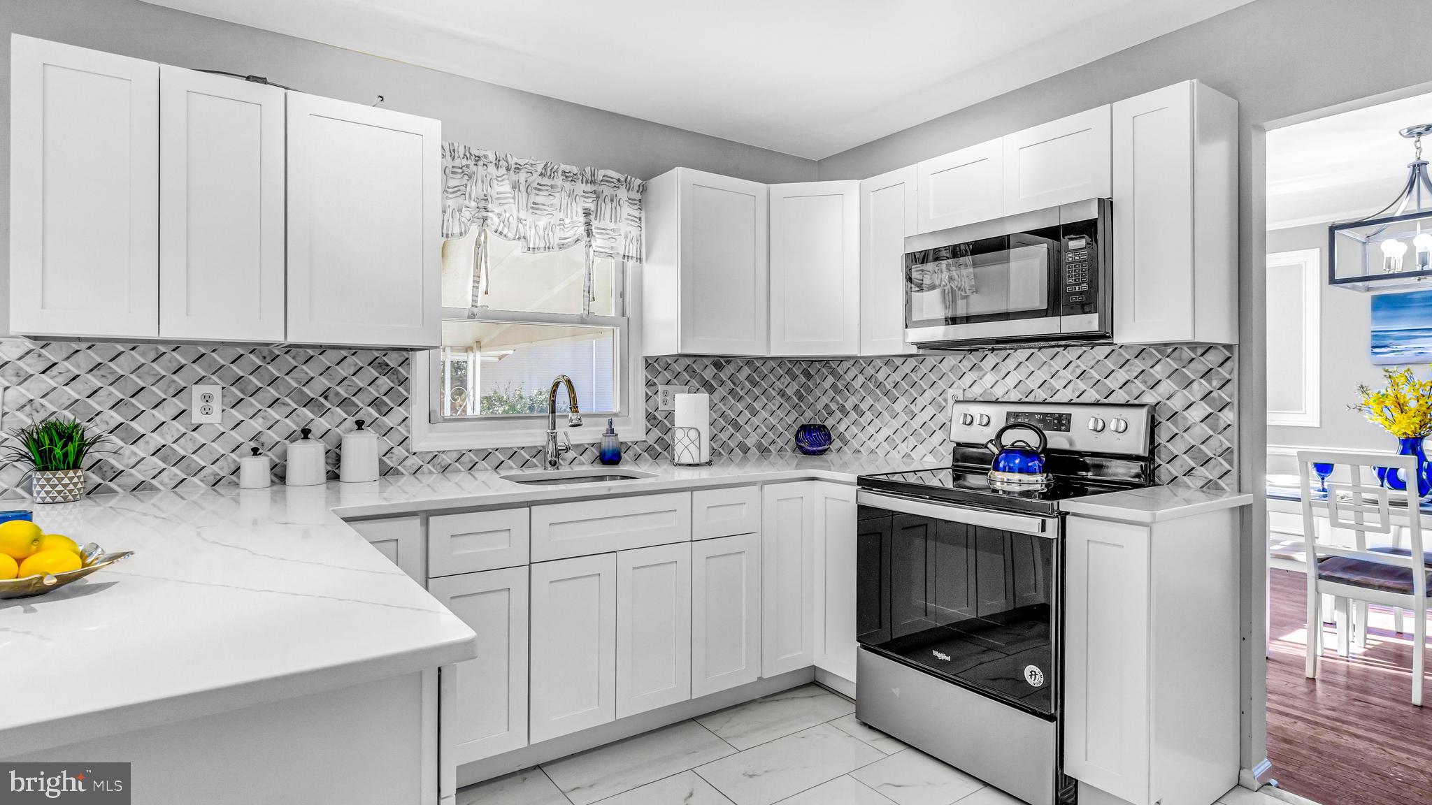 514 Arthur Drive Cherry Hill, NJ 08003 - Photo 12 of 33 a kitchen with a sink stove and cabinets
