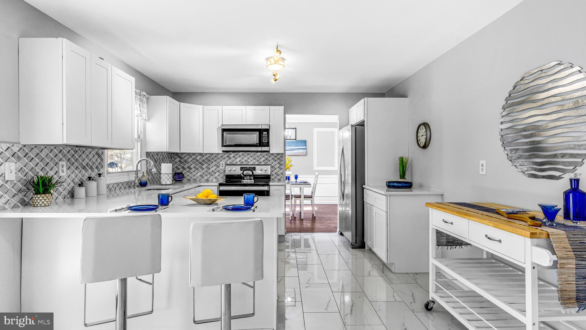 514 Arthur Drive Cherry Hill, NJ 08003 - Photo 14 of 33 a kitchen with stainless steel appliances a stove refrigerator sink and microwave