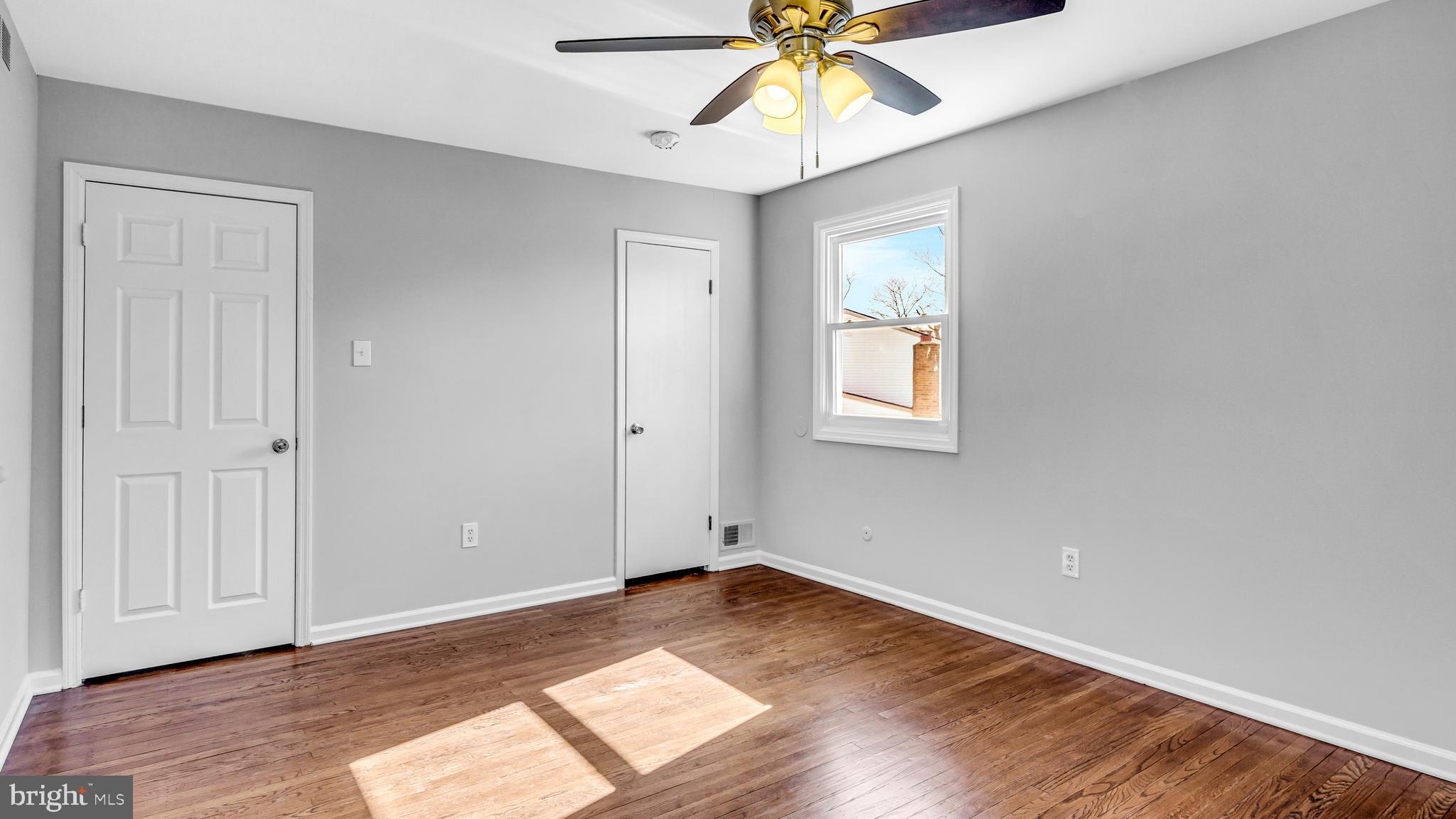 514 Arthur Drive Cherry Hill, NJ 08003 - Photo 22 of 33 an empty room with wooden floor and fan