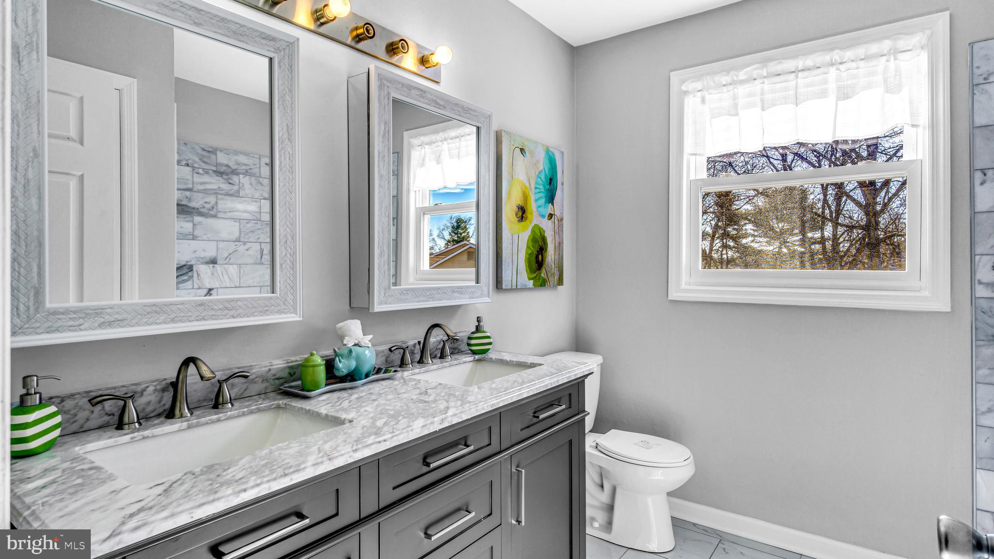514 Arthur Drive Cherry Hill, NJ 08003 - Photo 23 of 33 a bathroom with a granite countertop sink a toilet and a window