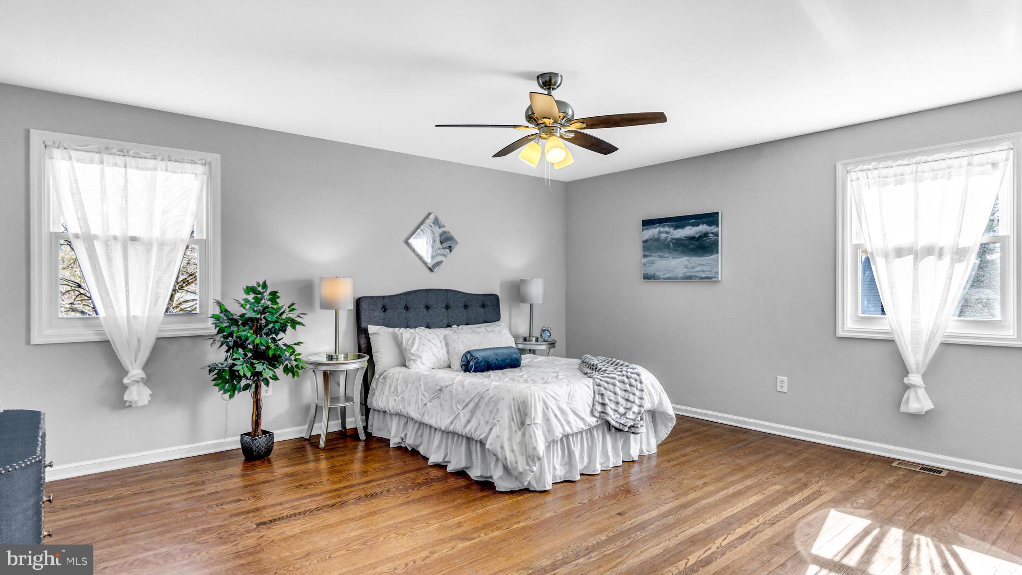 514 Arthur Drive Cherry Hill, NJ 08003 - Photo 25 of 33 a bedroom with a bed and a chandelier
