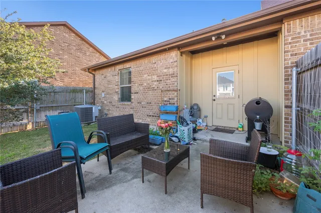a outdoor living room with furniture and a potted plant