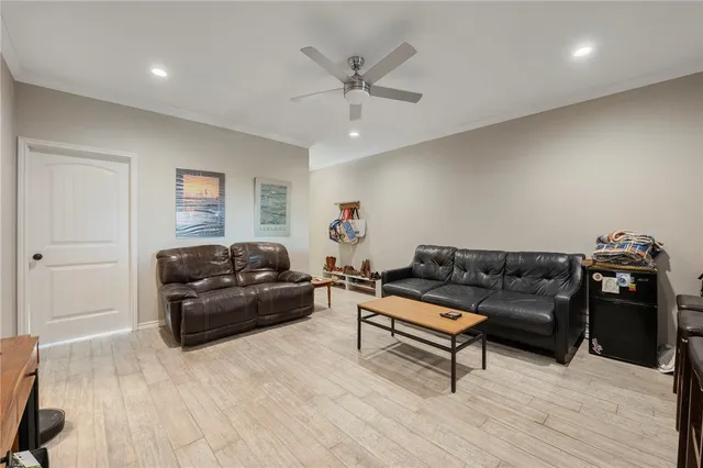 a living room with furniture and a wooden floor