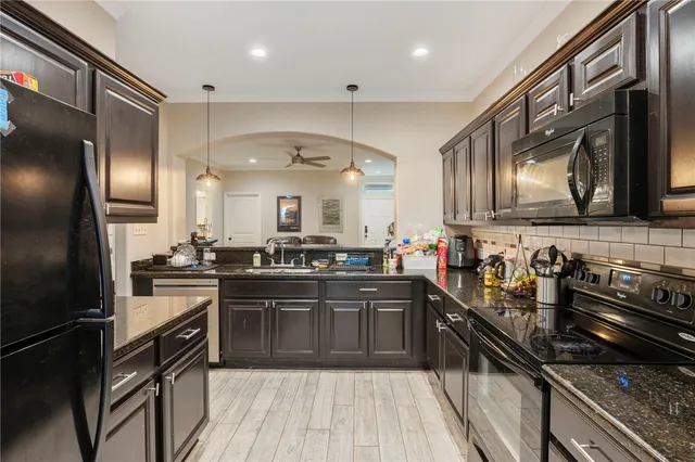 a kitchen with stainless steel appliances a sink stove and refrigerator