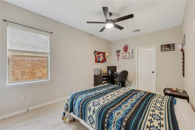 a bedroom with bed and a window