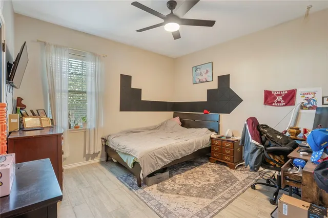 a bedroom with a bed and wooden floor