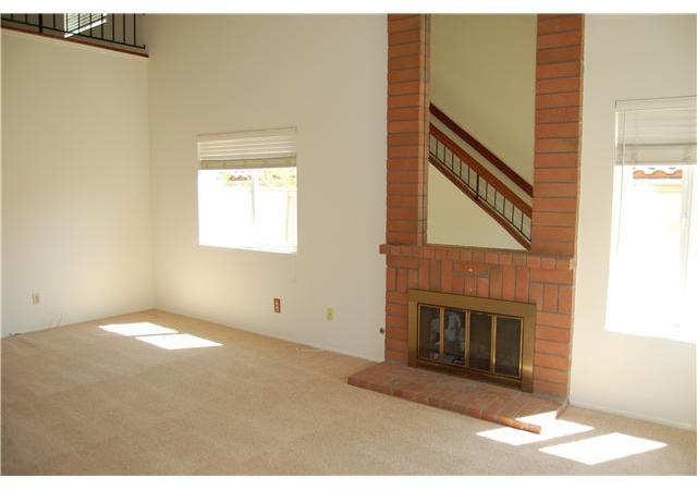 925 Alyssum Road Carlsbad, CA 92011 - Photo 2 of 10 Sunny living & dining room combo with fireplace.