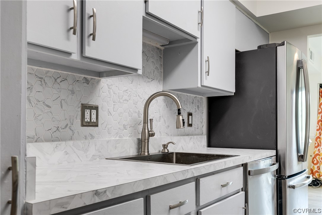 1509 Regency Woods Road, Unit 103 Henrico, VA 23238 - Photo 13 of 31 a kitchen with stainless steel appliances granite countertop a sink a refrigerator and a granite counter tops