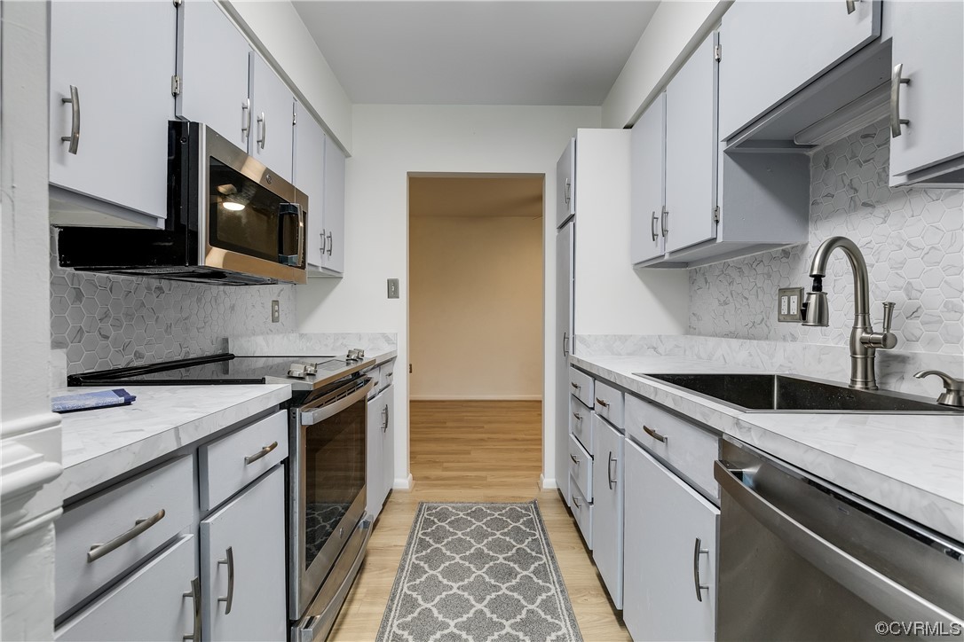 1509 Regency Woods Road, Unit 103 Henrico, VA 23238 - Photo 16 of 31 a kitchen with stainless steel appliances granite countertop a sink and a stove top oven