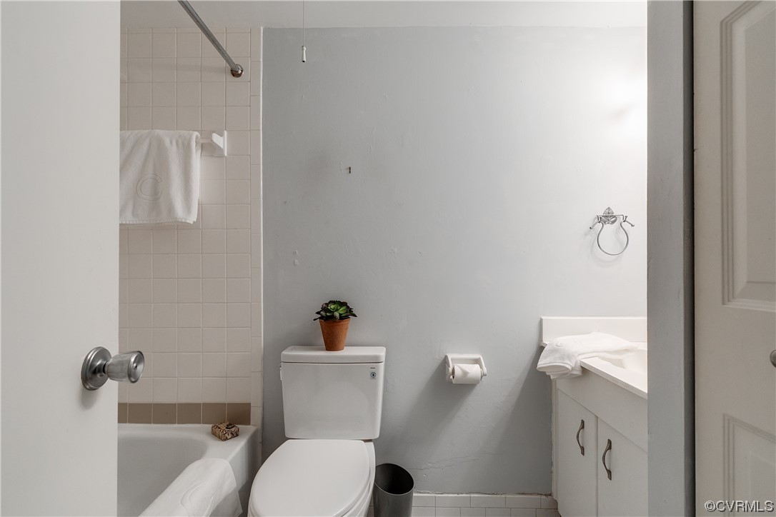 1509 Regency Woods Road, Unit 103 Henrico, VA 23238 - Photo 25 of 31 a white toilet sitting next to a bathroom sink and tub