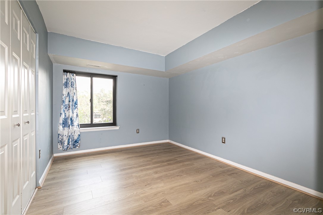 1509 Regency Woods Road, Unit 103 Henrico, VA 23238 - Photo 28 of 31 an empty room with wooden floor and windows