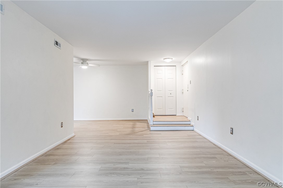 1509 Regency Woods Road, Unit 103 Henrico, VA 23238 - Photo 4 of 31 a view of an empty room with wooden floor and white walls