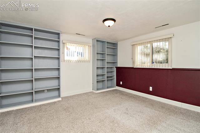 4595 Fox Road Cascade, CO 80809 - Photo 32 of 38 Family room with built ins and lots of light