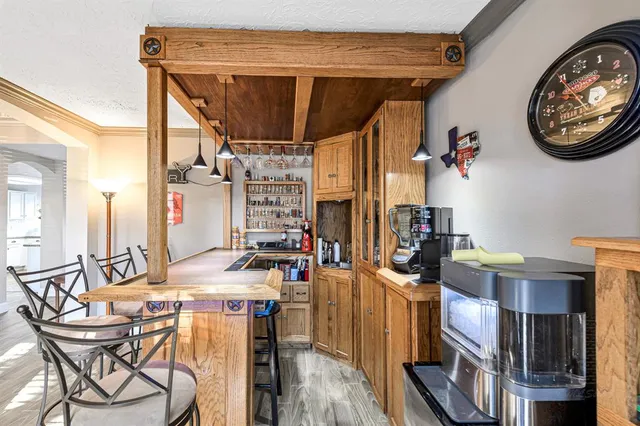 a view of a dining room with furniture and a chandelier