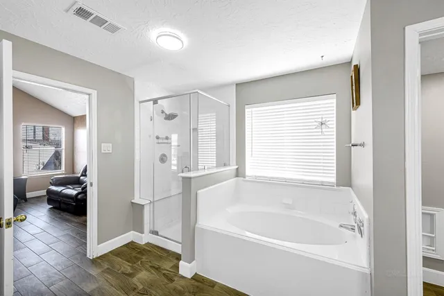 a bathroom with a bathtub and a shower