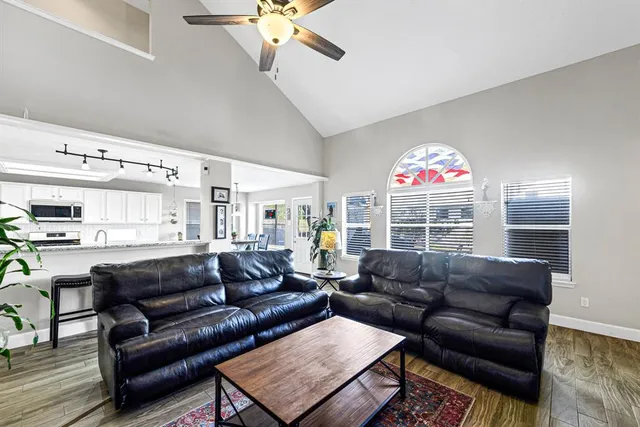 a living room with furniture a fireplace and a window