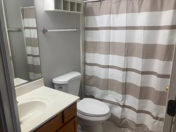a white toilet sitting next to a bathroom sink