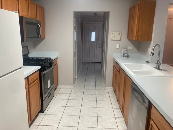 a kitchen with a sink a stove and a microwave